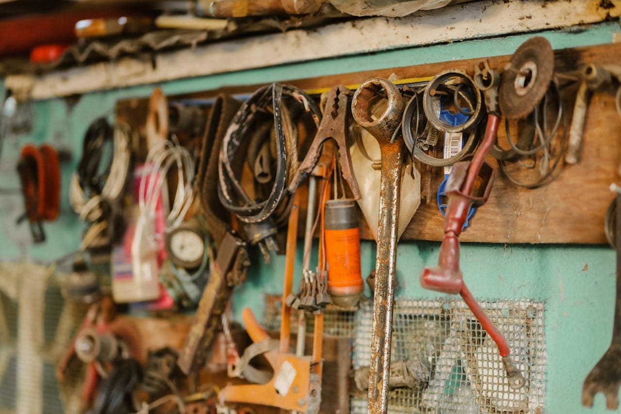 Mastering the First Impression: Your intriguing post title goes here A collection of vintage tools hanging on a workshop wall, showcasing a rustic and messy appeal.