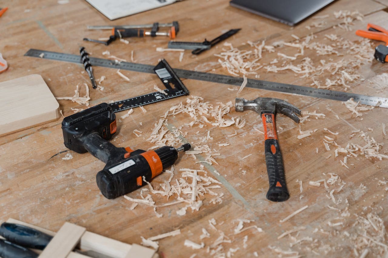 Crafting Captivating Headlines: Your awesome post title goes here A close-up view of various woodworking tools scattered on a wooden surface with sawdust.
